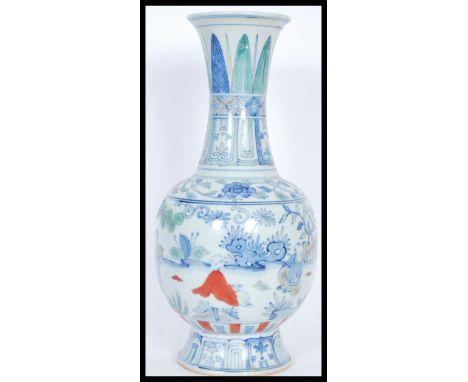 A Chinese baluster vase having hand painted decoration of children playing in scenes of trees and foliage with toys and music