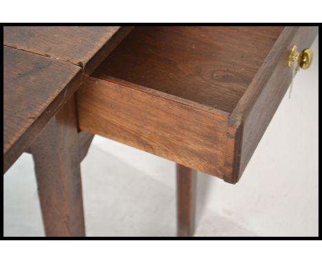 A 19th Century Georgian solid country oak large gate leg peg jointed dining / hunt table raised on square supports with twin 