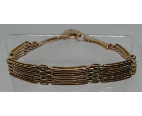 A 9ct gold five bar gate bracelet with heart shaped padlock clasp.  Approx weight 16.8 grams.(B.P. 21% + VAT) 