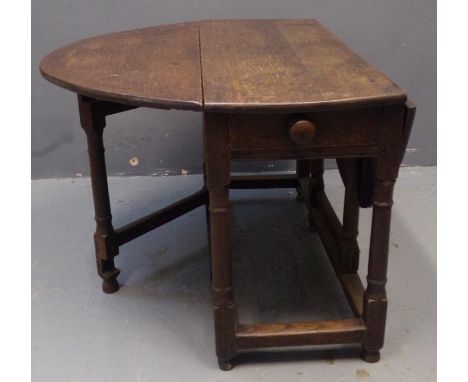 18th Century oak gate legged table, having single drawer above baluster turned legs and moulded stretchers. 123 x 111 x 66cm 