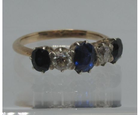 A sapphire and diamond four stone ring set in white metal with a yellow metal band. Ring size K. Approx weight 2.8 grams. (B.