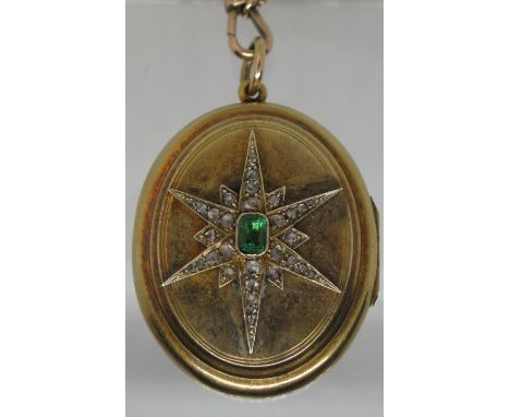 A Victorian oval locket set to the front with an emerald and diamond starburst. Approx weight 26.5 grams. (B.P. 21% + VAT)It 