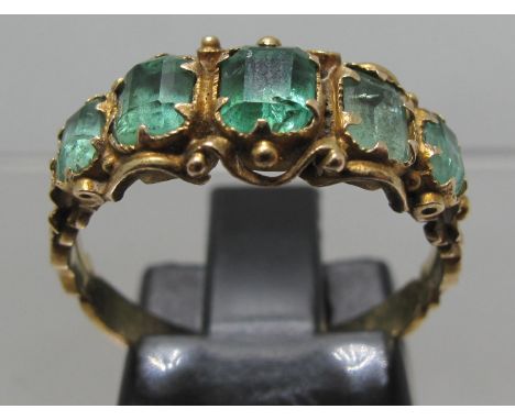 Victorian five stone emerald ring with engraved band. Ring size O. Approx weight 2.5 grams. (B.P. 21% + VAT)Additional photos