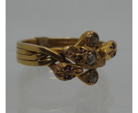 A 19th century triple snake puzzle ring set with three rose cut diamonds and cabochon ruby eyes. Ring size O. Approx weight 5