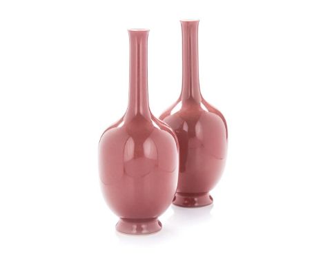 A PAIR OF CHINESE COPPER-RED ‘STICK-NECK’ VASES each ovoid body rising to a tall slender neck with a slightly everted rim, su