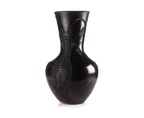 A TERRACOTTA HANDBUILT, CARVED, BURNISHED AND SMOKE FIRED VESSEL the flaring neck and globular body with incised insect desig
