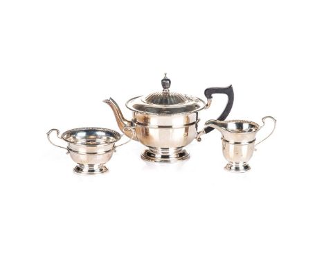 A THREE PIECE SILVER TEA SERVICE, ADIE BROS, BIRMINGHAM, 1930 AND 1931 of tapering circular form with half-lobed lower half, 