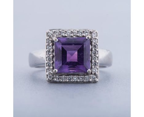 AN AMETHYST AND DIAMOND RING centred with a square step-cut amethyst weighing approximately 1.53cts, in a conforming surround