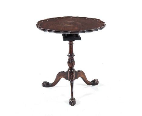 A GEORGE III MAHOGANY PIE-CRUST TILT-TOP TRIPOD TABLE the shaped circular top on a birds nest support, carved tapering turned