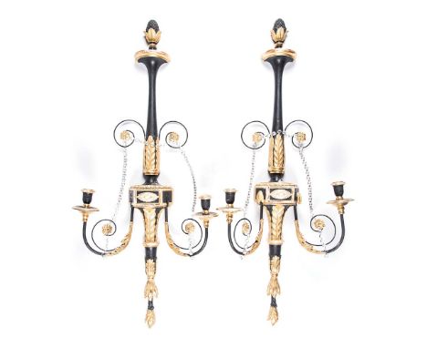 A PAIR OF TWO-LIGHT EBONISED AND GILTWOOD WALL SCONCES each drip tray on a scrolled acanthus-leaf arm joined to a central sha