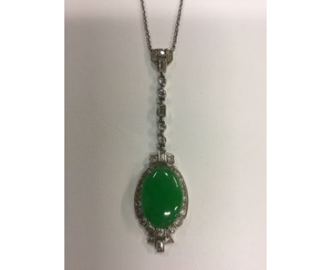 A circa 1930's 18ct and platinum jade set oval pendant with diamond surround and diamond set suspender.