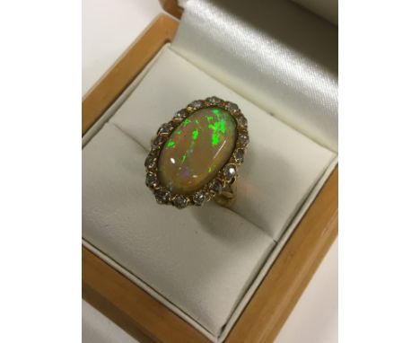 An 18ct gold and platinum set opal and diamond cluster ring