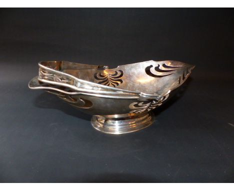 An Art Nouveau silver swing handled fruit basket on oval pedestal foot. Chester 1907. Makers Martin Hall &amp; Co. 12ozs.