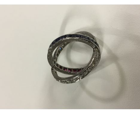 A circa 1930's diamond, sapphire and ruby set cocktail ring.
