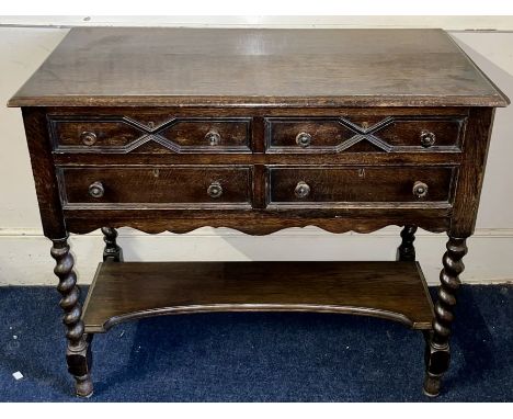 A 20th century oak sideboard, slight over sailing top above an arrangement of drawers, raised on barley twisted supports unit