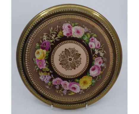 A good 19th C ceramic plaque decorated with hand-painted flowers and mounted in a gilt frame23.5cm good condition
