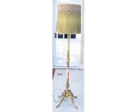 A mid 20th century floor lamp, gilt metal and onyx column, raised on four gilt metal cabriole legs, terminating in paw feet, 