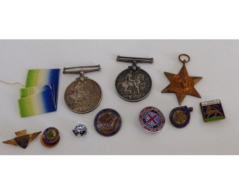 2 1914-1918 first world war service medals , a medal ribbon a second world war Atlantic star and a group of enamel badges . (