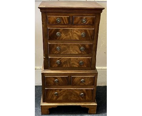 A George III revival mahogany crossbanded dwarf collectors chest on chest, moulded cornice above an arrangements drawers with