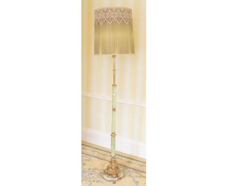 A mid 20th century floor lamp, gilt ad onyx column terminating with an ornate base, raised on a circular onyx base and three 