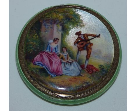 19th c silver gilt and enamel powder pack , decorated with a scene of a man playing an musical instrument to 2 ladies . 5.5cm