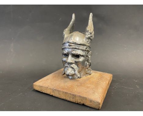 A Rover car mascot in the form of a Viking head, display base mounted.