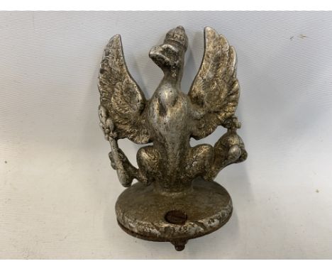 A car accessory mascot in the form of a griffin, unusual form and of light material.