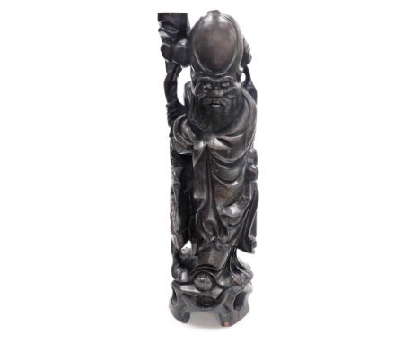 A Chinese hardwood figure of the god Shou-Lau, god of longevity, with wire work inlay, modelled standing holding a staff and 