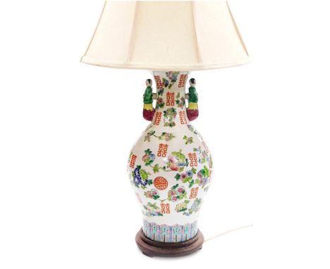 A late 20thC Chinese famile rose porcelain table lamp, of twin figural handle baluster form, decorated with peaches, vector s