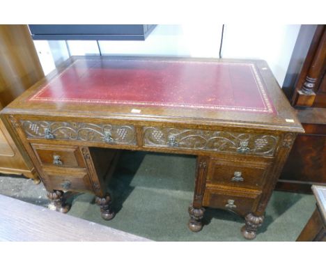 Red leather tooled top carved fronted oak writing desk 