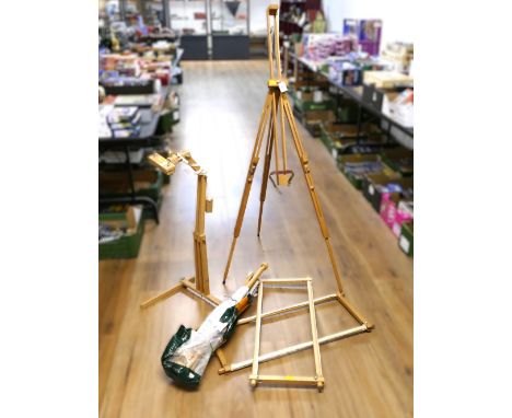 Wooden folding adjustable artist's easel, tapestry frame and another crafting stand.