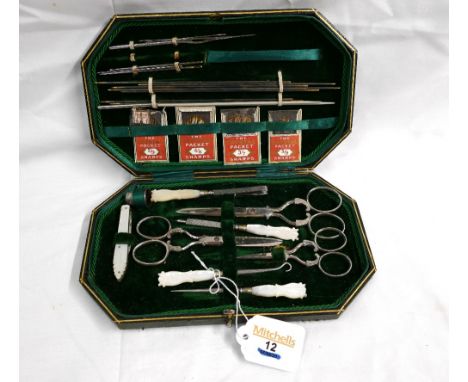 A vintage sewing kit in green leather box, mother of pearl handles, including a silver hallmarked thimble.