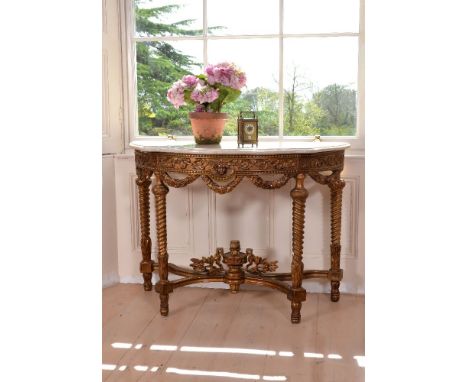 A carved giltwood and marble topped console table, late 19th century,  of semi-elliptical outline, the marble top above scrol