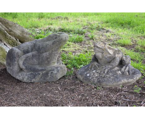 A stone composition model of a toad, naturalistically cast on a rocky base, 43cm high, together with a similar and smaller mo