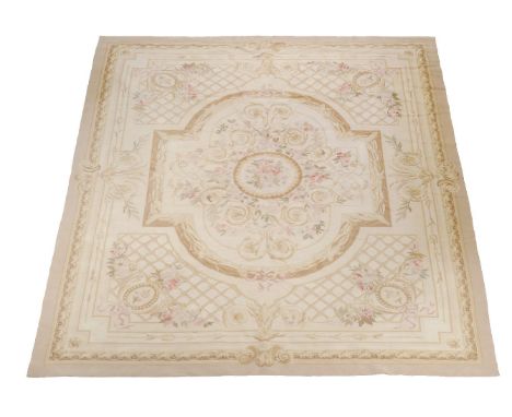 A woven carpet, in Aubusson style, decorated with neoclassical motifs in pastel colours on a pale cream field, approximately 