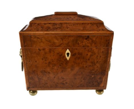 Y A Regency yew and burr yew wood tea caddy, circa 1815, of sarcophagus form, the hinged cover and front with crossbanded bor