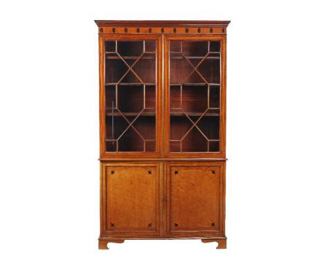 A mahogany banded and inlaid bookcase cabinet, 19th century, the glazed doors enclosing adjustable shelves, the cupboard door