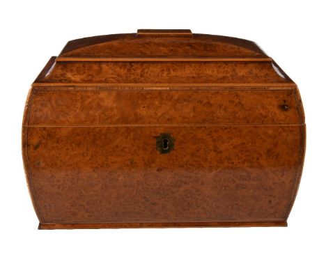 A substantial George IV amboyna tea caddy, circa 1825, of bombe sarcophagus form, the hinged cover, angles and front with cro