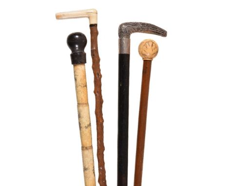 Y Four various walking sticks, the first Chinese sectional bone, early 20th century, with a hardwood rounded knop, incised wi