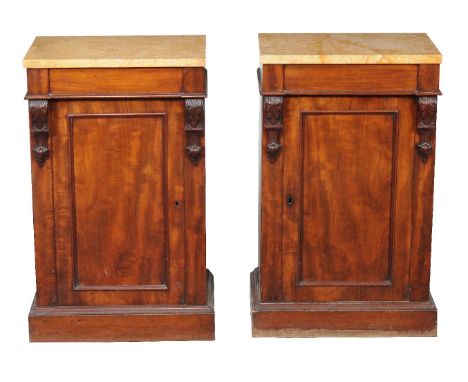 A pair of mahogany and yellow pink veined marble topped pedestal cabinets, circa 1860 and later, each panel door enclosing a 