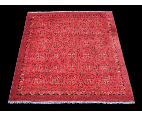 A Bokhara carpet, of overall design, the madder field decorated with foliate and geometric motifs in dark navy and cream high
