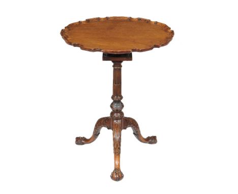 A George III mahogany piecrust tripod table, circa 1770, with birdcage action, the stem and legs carved with stop fluting and