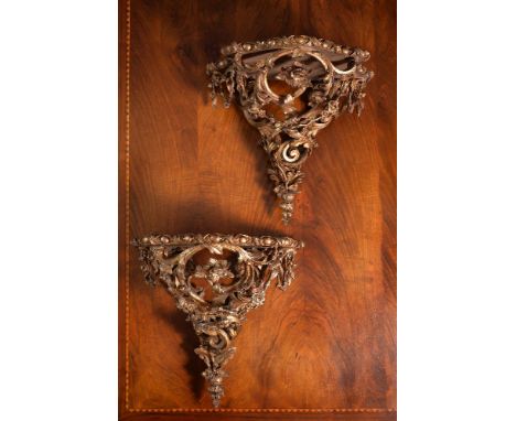 A pair of giltwood and composition wall brackets or small console tables,  second half 19th century, of serpentine fronted ta