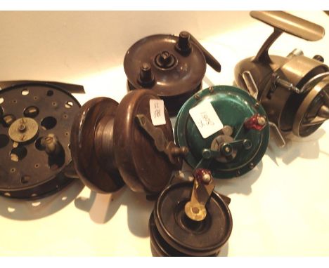 Collection of six vintage fishing reels including wooden and brass examples. P&amp;P Group 2 (£18+VAT for the first lot and £