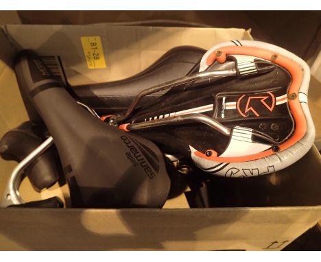 Three like new racing bike saddles and four pairs of good quality racing bike levers. P&amp;P Group 1 (£14+VAT for the first 