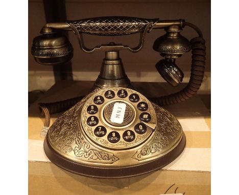 The Duchess, push button telephone with a solid, brass finish and traditional cloth handset curly cord. Compatible with stand