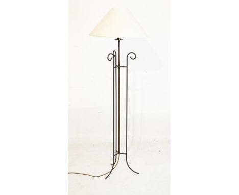 Metal standard lamp of tubular design with central stem between three scroll supports   Condition: 