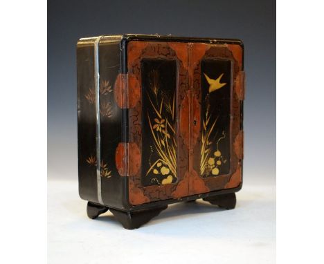 Japanese lacquered table cabinet, Meiji period having gilt decoration depicting birds amongst foliage on a black ground, the 