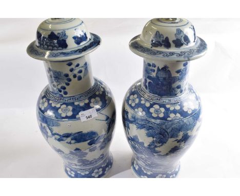 A large pair of 19th Century Chinese porcelain vases and covers decorated in Kangxi style with panels of birds amongst foliag