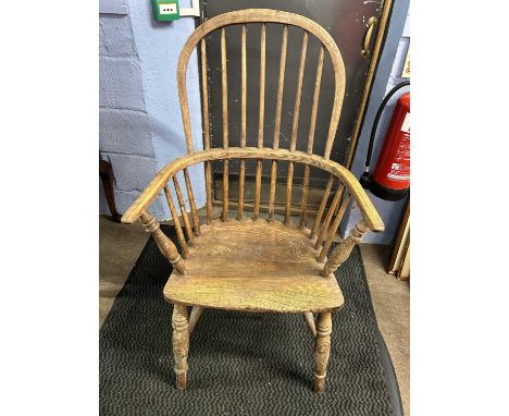 A 19th Century elm seated stick back Windsor chair raised on turned legs with a central H stretcher, 107cm high (a/f)